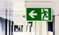 green emergency exit sign in a building